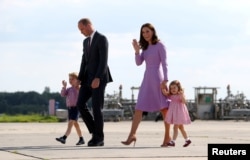 FILE - Britain's Prince William, the Duke of Cambridge, his wife Princess Catherine, the Duchess of Cambridge, Prince George and Princess Charlotte walk at the airfield in Hamburg Finkenwerder, Germany.