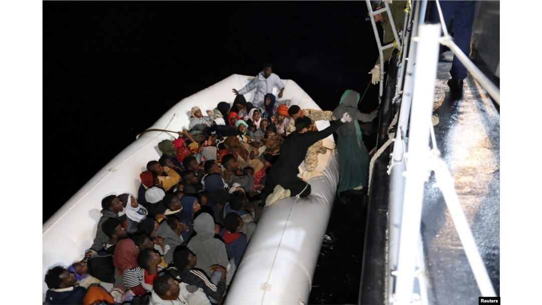 Migrants in a dinghy are rescued by Libyan members of the coast guard in the Mediterranean Sea off the coast of Libya, March 15, 2018.