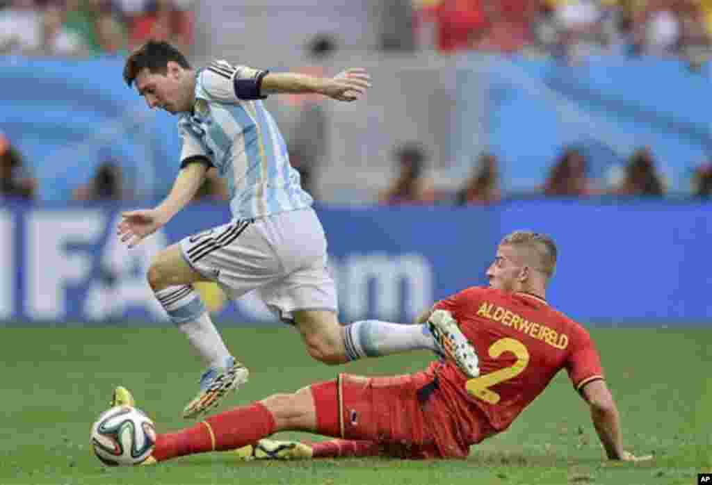 Argentina's Lionel Messi skips over the challenge of Belgium's Toby Alderweireld during the World Cup quarterfinal soccer match between Argentina and Belgium at the Estadio Nacional in Brasilia, Brazil, Saturday, July 5, 2014. (AP Photo/Martin Meissner)