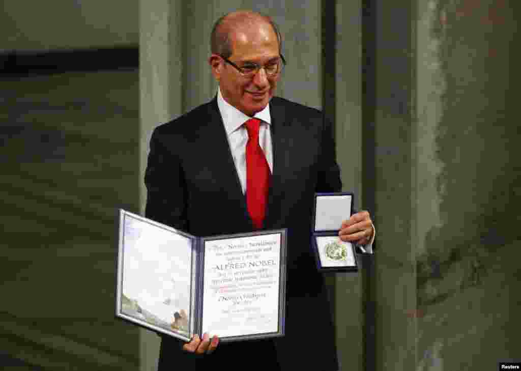 Ahmet Uzumcu, director general of the Organisation for the Prohibition of Chemical Weapons (OPCW) holds the medal and the diploma during the Nobel Peace Prize awards ceremony at the City Hall in Oslo, Norway.