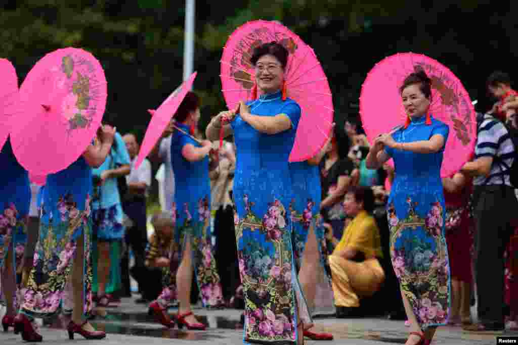 Women take part in a Cheongsam Show ahead of International Women&#39;s Day in Qionghai, Hainan province, China.