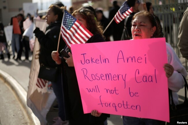 A woman holds a placard for Jakelin Caal Maquin, a 7-year-old Guatemalan girl who died in U.S. custody after crossing illegally from Mexico to the U.S., during a protest held to demand justice for her in El Paso, Texas, Dec. 15, 2018.