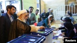 FILE - Ali Akbar Nategh-Nouri casts his vote into a ballot box during the presidential election in Tehran, Iran, May 19, 2017. (TIMA via Reuters)