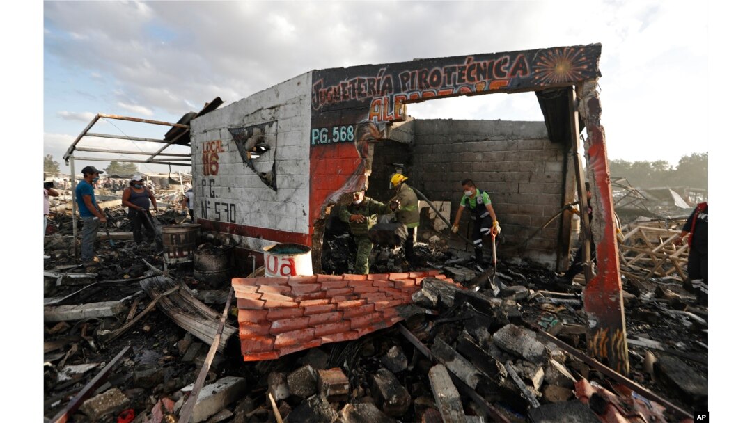 Firefighters and rescue workers remove debris from the scorched ground of Mexico's best-known fireworks market after an explosion explosion ripped through it, in Tultepec, on the outskirts of Mexico City, Mexico, Dec. 20, 2016.