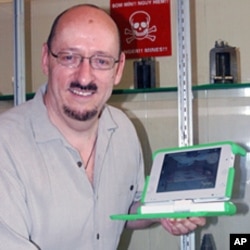 Professor Frank Biocca, one of the game's developers, holds a One Laptop Per Child Computer during his recent trip to assess the game's effect on learning about the dangers of landmines (File)