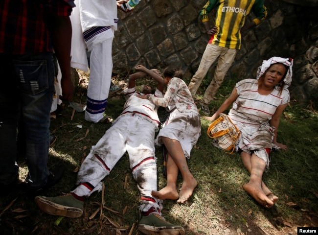 FILE - Injured protesters wait for help after several people died during the Irrechaa, the thanksgiving festival of the Oromo people in Bishoftu town of Oromia region, Ethiopia, Oct. 2, 2016.