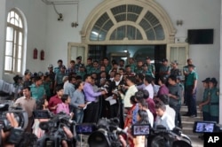 Prosecutor, Sultan Mahmud Simon, center, wearing black coat, talks to the media in front of a special war crimes court after the court sentenced four men to death in Dhaka, Bangladesh, Tuesday, May 3, 2016.