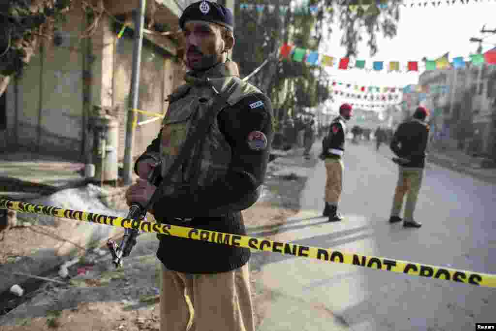 A police officer cordons off the site of a suicide blast in Rawalpindi, Pakistan, Jan. 20, 2014.