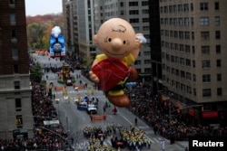 A giant Charlie Brown balloon makes floats down 6th Avenue in New York City during the 90th Macy's Thanksgiving Day Parade, 2016. (REUTERS/Saul Martinez)