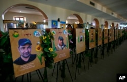 In this Friday, Feb. 1, 2019 photo, commemorative images of militiamen who died fighting the Islamic State group over the past four years, and their weapons are on display in the Popular Mobilization Forces War Museum on al-Mutanabi Street, Baghdad, Iraq.