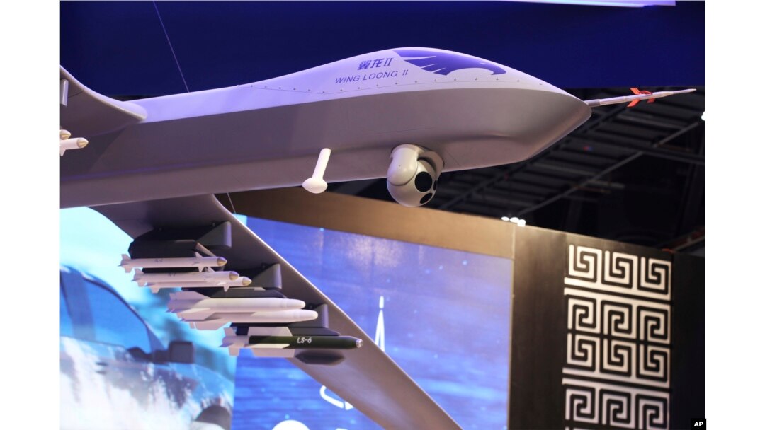 A model of a Wing Loong II weaponized drone hangs above the stand for the China National Aero-Technology Import & Export Corp. at a military drone conference in Abu Dhabi, United Arab Emirates, Feb. 25, 2018.