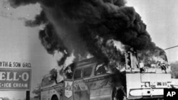 FILE - A May 1961 file photograph of a Freedom Rider bus that went up in flames when a fire bomb was tossed through a window near Anniston, Alabama