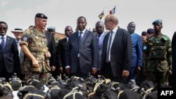 FILE - French Defense Minister Jean-Yves Le Drian (C) flanked by President of the Central African Republic Faustin-Archange Touadera (2ndL), looks at military supplies at the Mpoko military base in Bangui, Oct. 31, 2016.