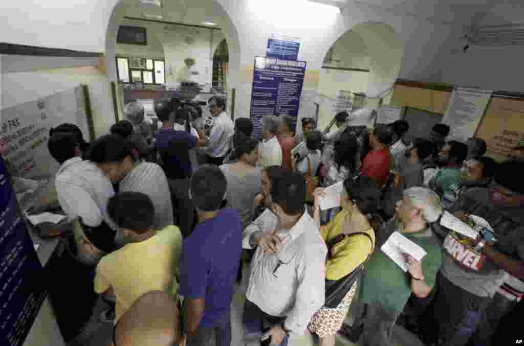 Indians line up to send telegrams on the last day of the service at a telegraph office in New Delhi, July 14, 2013.