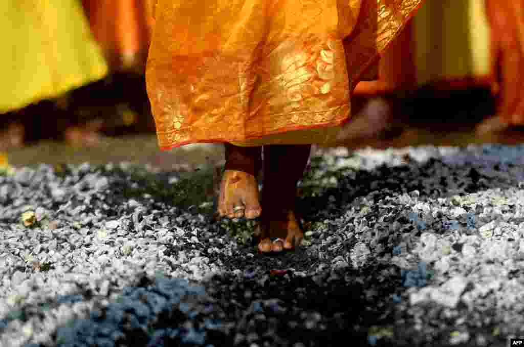 A Hindu devotee walks over burning coals during the Thaipoosam festival in Chennai, India.