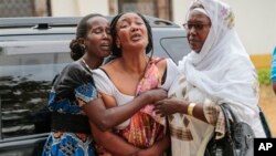 Relatives and friends grieve during the funeral of Patrick Ndikumana, Friday, July 3, 2015, in Bujumbura, Burundi. According to relatives Ndikumana was killed in the police attack in Jabe neighborhood last week. A U.N. observer mission concluded Thursday that this week's parliamentary elections in Burundi were not "free, credible and inclusive." ((AP Photo/Bertheir Mugiraneza)