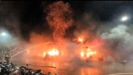 In this image taken from video by Taiwan's EBC, firefighters battle a blaze at a building in Kaohsiung, in southern Taiwan, Oct. 14, 2021.
