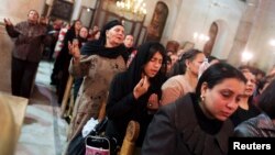Coptic Christians pray at St Mark Cathedral in Cairo, Dec. 26, 2014.