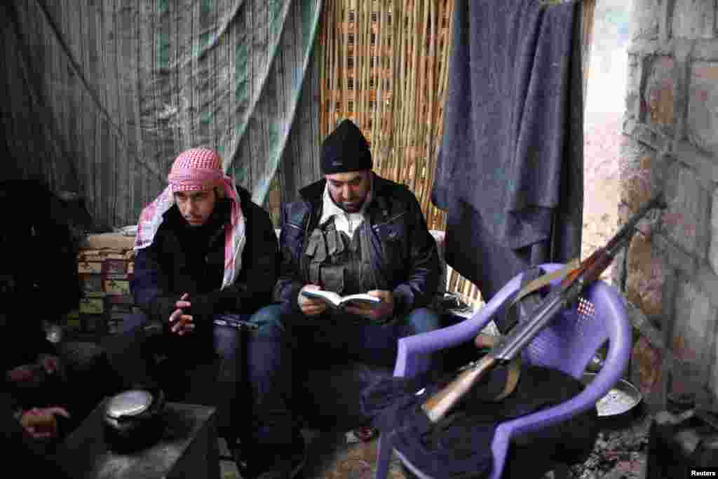 20일 알레포 시에서 전우와 나란히 앉아 코란을 읽는 반군 병사.