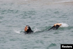 A Muslim woman wears a burkini, a swimsuit that covers most of the body, as she swims in Marseille, France, August 17, 2016.