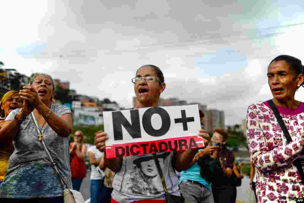 Venezuelan opposition activists march along a street of Caracas, March 31, 2017 chanting slogans against the government of President Nicolas Maduro.