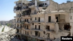 A view of a street with damaged buildings in Aleppo's Salaheddine neighborhood, July 9, 2013.