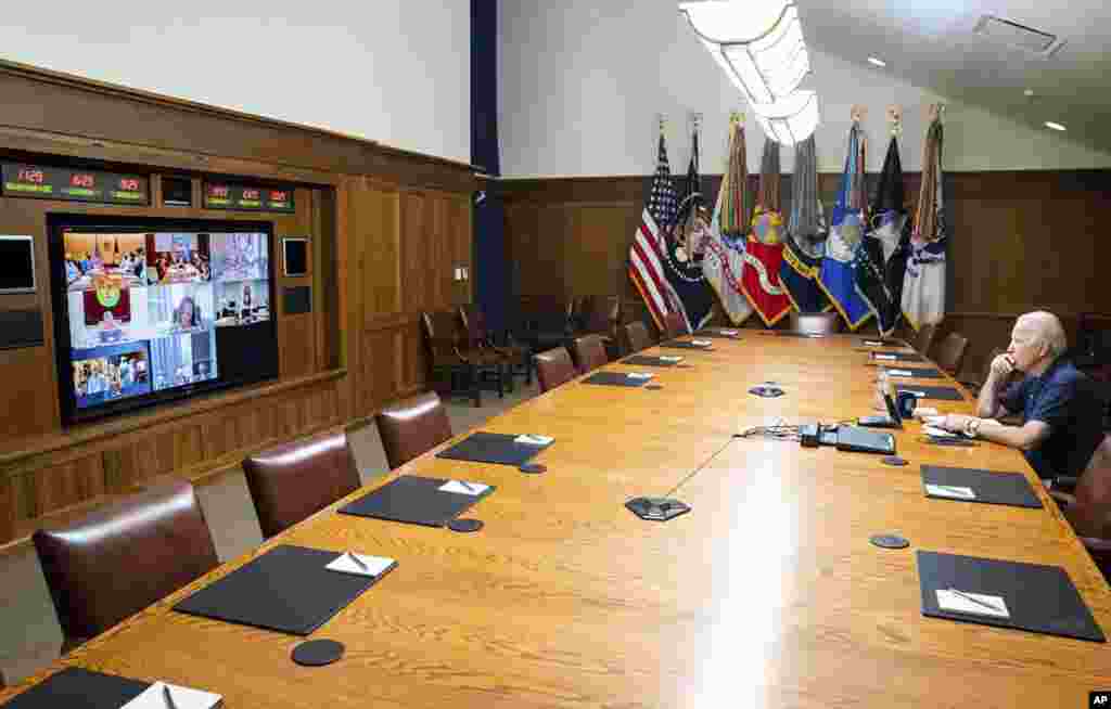 In this photo released by The White House, President Joe Biden meets virtually with his national security team and senior officials for a briefing on Afghanistan, Aug. 15, 2021, at Camp David, Maryland.