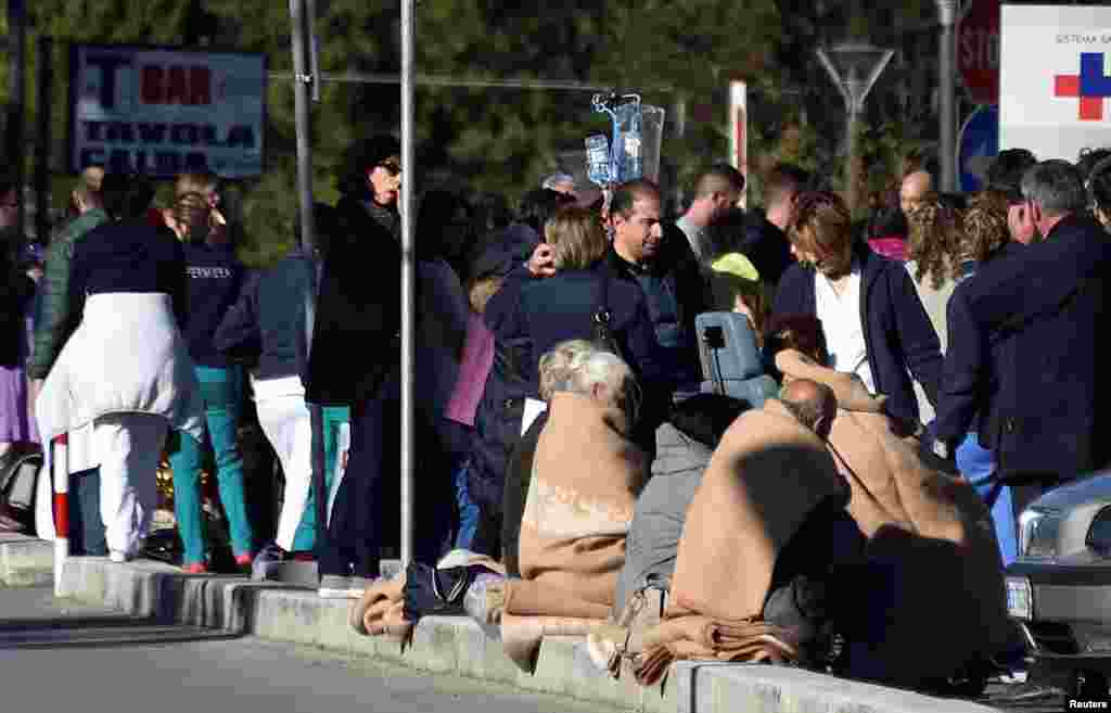 People evacuated from an hospital are covered with blankets following a quake in Rieti, Italy, Oct. 30, 2016.