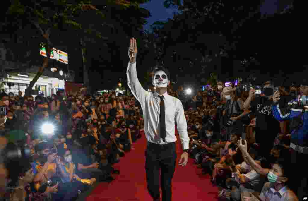 Pro-democracy protesters perform a fake &quot;red carpet&quot; fashion show said to be a counterpoint to a fashion show being held by one of the monarchy&#39;s princesses nearby in Bangkok, Thailand.