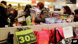 FILE - Shoppers wait to pay for their purchases in the Toys R Us store in New York's Times Square, March 23, 2018. 