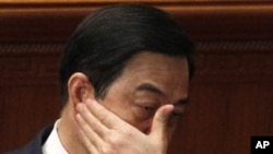 Chongqing party secretary Bo Xilai rubs his face during a session of the National People's Congress held in Beijing, March 9, 2012.
