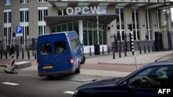 United Nations inspectors arrive in a van at the headquarters of the Organisation for the Prohibition of Chemical Weapons (OPCW), in The Hague, Aug. 31, 2013. 