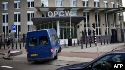 United Nations inspectors arrive in a van at the headquarters of the Organisation for the Prohibition of Chemical Weapons (OPCW), in The Hague, Aug. 31, 2013. 