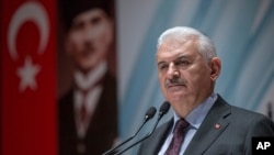 FILE - Turkey's Prime Minister Binali Yildirim speaks to the country's security chiefs in Ankara, Jan. 18, 2018. In an interview he hinted at an end to Turkey's emergency rule, put into force in 2016 after a failed coup attempt.