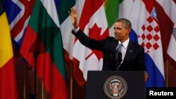 U.S. President Barack Obama waves after his speech at the Beaux-Arts concert hall in Brussels March 26, 2014