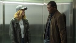 This image released by Disney-Marvel shows Samuel L. Jackson, right, with Brie Larson on the set of "Captain Marvel."
