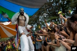 A reveler in a werewolf costume performs on stilts during the Terreirada Cearense street carnival party in Rio de Janeiro, Brazil, Feb. 10, 2018.