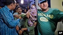 Mohammad Salim Shaikh, one of the two suspects arrested by police in the gang rape of an elderly nun nearly two weeks ago, is brought to the Crime Investigation Department office in Kolkata, India, March 26, 2015. 