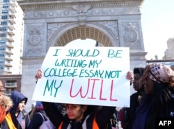 Students from Harvest Collegiate High School stand in Washington Square Park on March 14, 2018 in New York to take part in a national walkout to protest gun violence, one month after the shooting in Parkland, Florida, in which 17 people were killed.