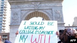 Students from Harvest Collegiate High School stand in Washington Square Park on March 14, 2018 in New York to take part in a national walkout to protest gun violence, one month after the shooting in Parkland, Florida, in which 17 people were killed.