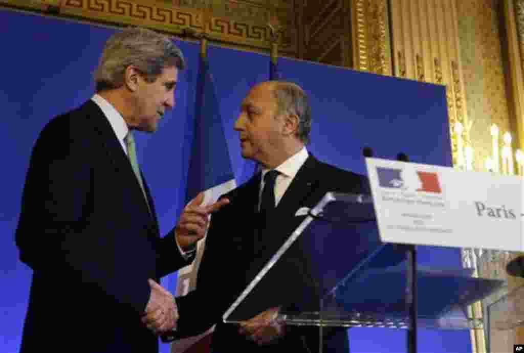 U.S. Secretary of State John Kerry, left, shakes hands after a news conference with French Minister of Foreign Affairs Laurent Fabius at the Foreign Ministry in Paris on Wednesday, Feb. 27, 2013. Paris is the third leg of Kerry's first official overseas t