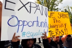 Students calling for diversity protest outside the U.S. Supreme Court in Washington October 10, 2012.