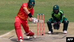 FILE: Zimbabwe's Craig Ervine (L) plays a shot as Pakistan's Mohammad Rizwan (R) looks on during the first Twenty20 international cricket match between Zimbabwe and Pakistan at the Harare Sports Club in Harare on April 21, 2021. (AP)