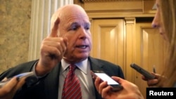FILE - U.S. Senator John McCain talks to reporters on Capitol Hill in Washington.