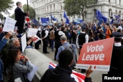 FILE - Brexit supporters form a counter demonstration as Pro-Europe demonstrators protest during a "March for Europe" against the Brexit vote result earlier in the year, in London, Britain, Sept. 3, 2016.