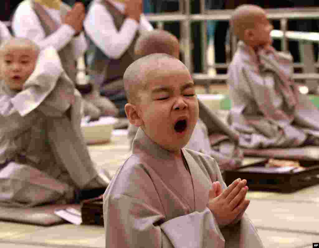 A boy yawns during a ceremony ahead of Buddha&#39;s upcoming birthday on May 17 at the Jogye temple in Seoul, South Korea. Ten children entered the temple to have an experience with life as monks which lasts for 16 days. 