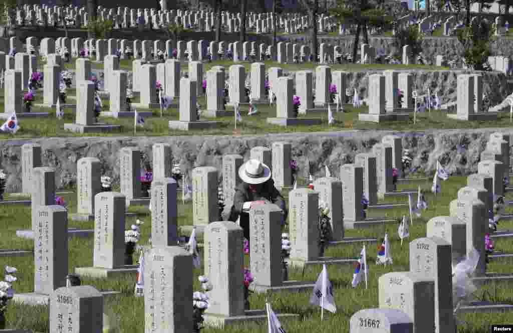 South Korean Jo Kyung-ho pays respect to his brother Jo Chang-ho who died during the 1950-1953 Korean War, on the eve of South Korea&#39;s Memorial Day at the National Cemetery in Seoul.