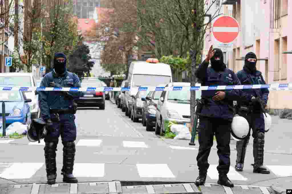 'Yan sanda cikin damara a unguwar Molenbeek ta Brussels a Belgium, Litinin 16 Nuwamba 2015, inda a yanzu haka 'yan sandan ke kai sumame cikin wasu gidaje na wannan unguwar da mafi yawan Musulmi na kasar ke zaune ciki.