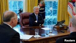 U.S. President Donald Trump smiles during an interview with Reuters at the White House in Washington, Jan. 17, 2018.