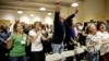 FILE - Attendees sing a song at the Sunday Assembly, a godless congregation founded by British comedians Sanderson Jones and Pippa Evans, Los Angeles, California.